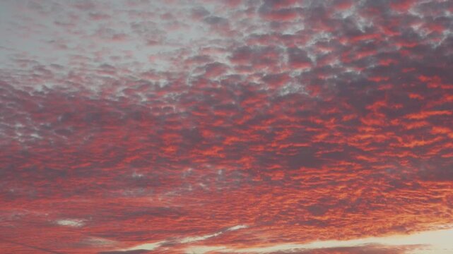 4K time lapse footage of red clouds glow changing color and vanishing in sunset, close up view of beautiful cloudscape in nature, b roll shot.