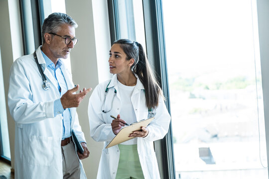 Male and female doctor discuss healthcare in the hospital