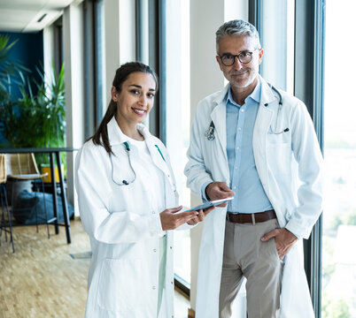 A male and female doctor hold a tablet in the hospital