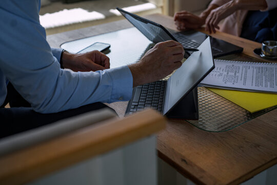 Man and woman discuss a contract at the office table