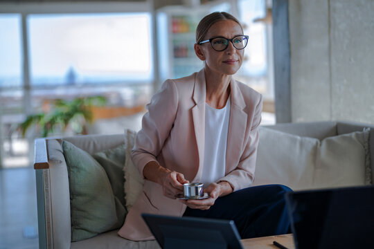 Businesswoman discusses a contract with coffee at the office