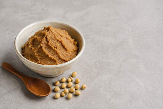 Japanese miso paste with soybeans and wooden spoon