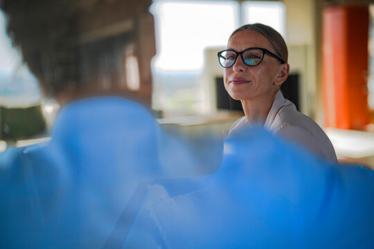 A businesswoman discusses a contract during a meeting at the office