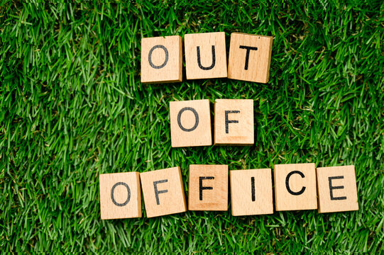 out of office sign on grass