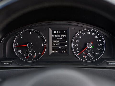 Vehicle dashboard view with speedometer and tachometer