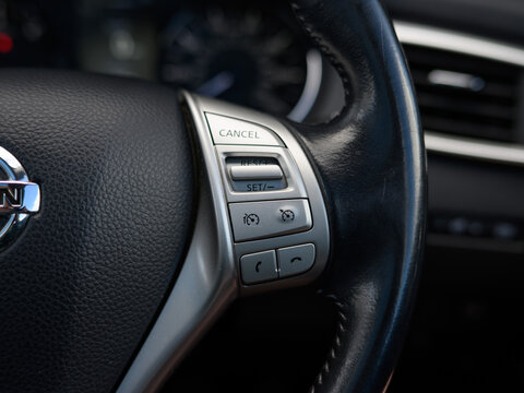 Focus on steering wheel's cruise control panel