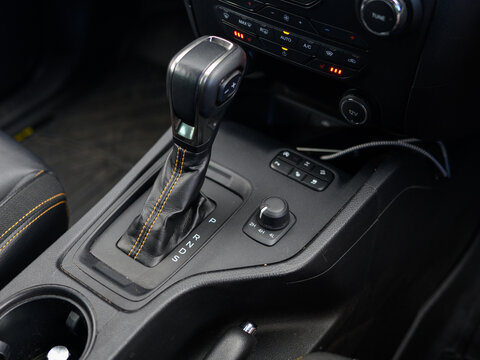 Close-up of modern car gear shift with green indicator light