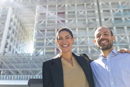 Business colleagues share a happy moment outdoors