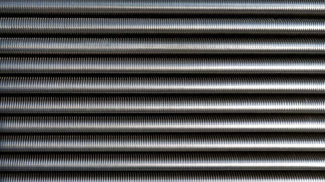 Elegant photo of A detailed close-up shot of parallel steel threaded rods arranged in a symmetrical pattern. Ideal for industrial, manufacturing, and construction technology.
