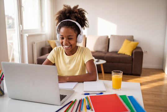  Smiling African American student attending virtual class at home table. Concept of e-learning, education, and for World Student Day