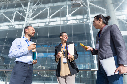 Business colleagues enjoy a coffee break outside a modern office