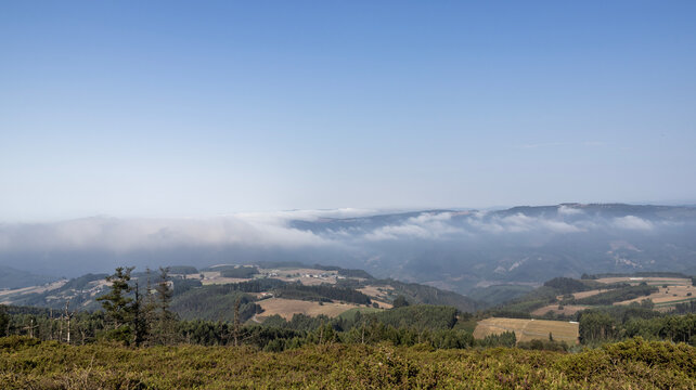 Panoramic landscape of hills and low sea of clouds with copy space
