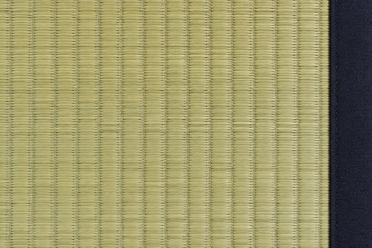 Japanese tatami rush mat texture with dark fabric border