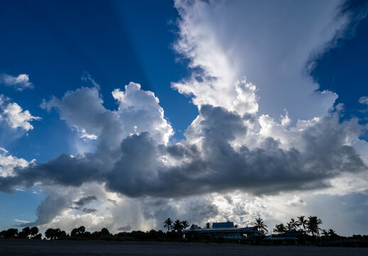 Sun behind early morning clouds in blue sky over southwest Florida USA