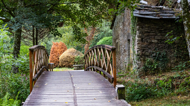 Wooden bridge and traditional stone hut in natural park