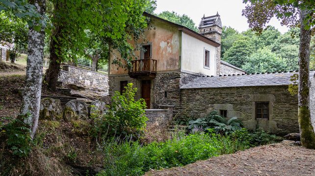 Traditional stone watermill with grinding millstones in rural setting