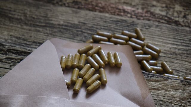 Capsules supplements of herbs and alternative medicine. Homeopathic medicine, nutritional supplement . Grunge wooden background