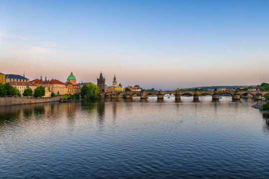 The Vltava river flows past the historic Charles Bridge in Prague