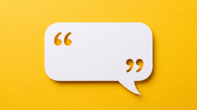 Minimalist white speech bubble with quotation marks on yellow background. Blank paper chat box for quotes and messages. Creative communication concept.