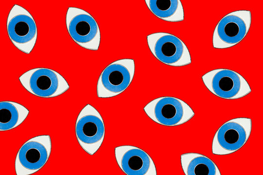 Blue eyes form a contemporary pop art pattern on a red background