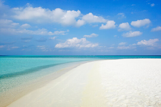 Pristine white sand beach meets turquoise ocean in the Maldives