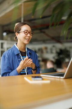 Smiling businesswoman talking on a video call at the coworking office