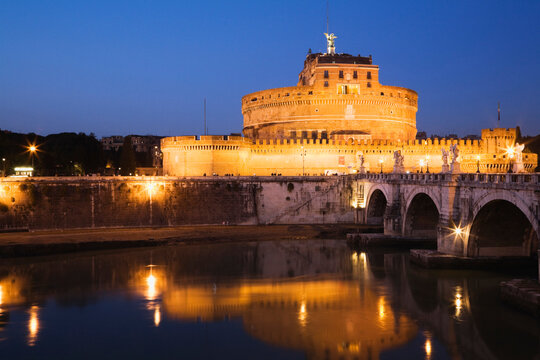 Italy, Rome, View of castle Sant Angelo with bridge and river at night