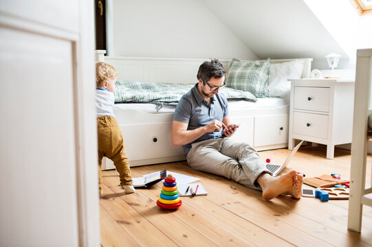 Father with his little son working from home