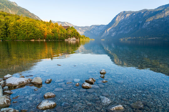 Clear water reflects mountains at Lake Bohinj in Slovenia