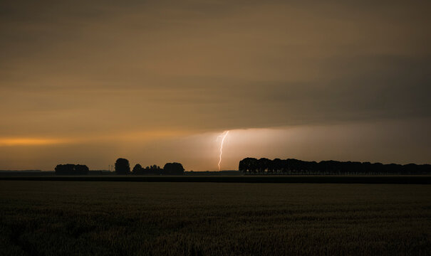 Lightning strikes over rural field near Moerdijk the Netherlands at night