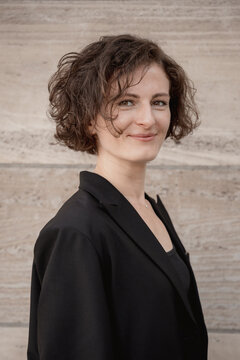 A confident businesswoman wears a black blazer