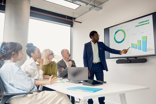 Businessman gives a presentation to a team in a London office
