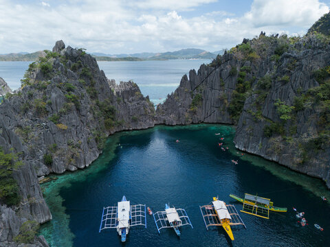 Boats anchor in the turquoise water of Twin Lagoon in Coron