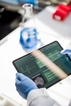 Male scientist analyzing medical data on a tablet in a laboratory