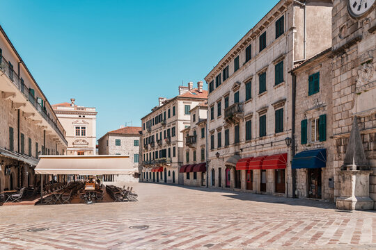 Historic architecture surrounds the empty town square in Kotor