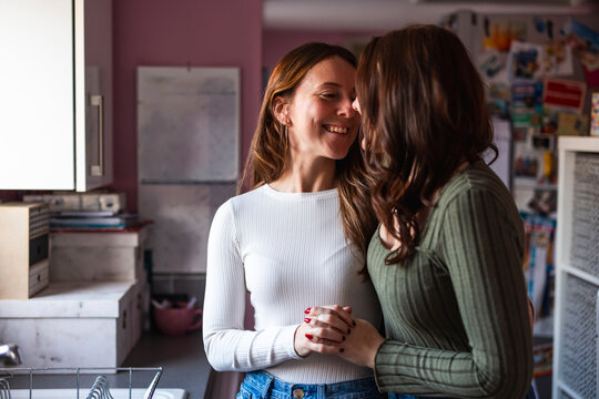 Lesbian couple sharing an intimate and affectionate moment at home