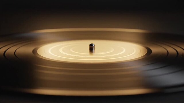 Close up of a vinyl record rotating on a turntable in a dark studio