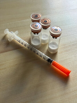 Reta, retatrutide peptide in a vial and bacteriostatic water on a wooden background