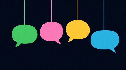 Obraz premium Four colorful speech bubbles hang on strings against dark backdrop. Green, pink, yellow, blue shapes represent communication, ideas. Simple graphic art suggests conversation, dialogue, message