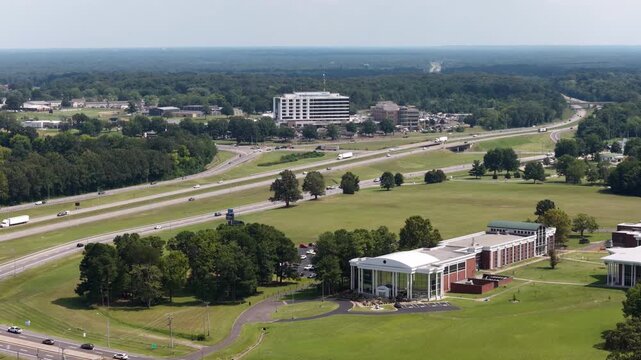 Aerial of institutional buildings and Interstate 24 in Paducah Kentucky in wooded rural countryside