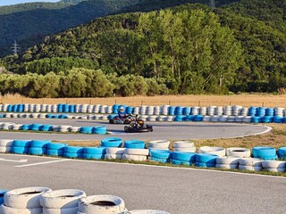 Go kart racing on circuit. Blue and white circuit for karting. © dianacoman
