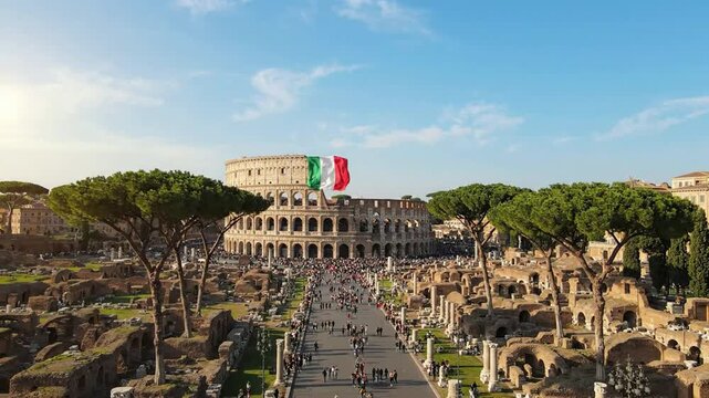Aerial view of the roman colosseum in rome with italian flag waving under sunny blue sky iconic historical landmark and travel destination