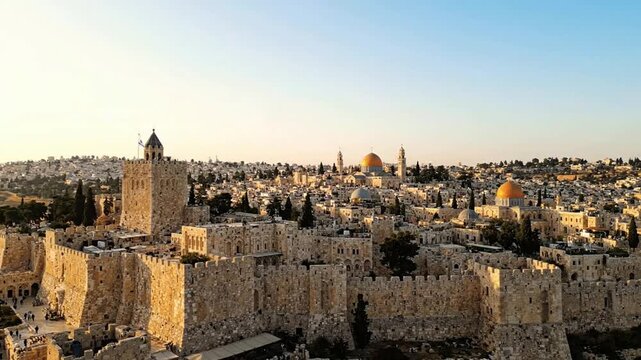 Aerial view of jerusalem old city with waving israeli flag at tower of david, iconic golden dome of the rock and ancient stone walls at sunset