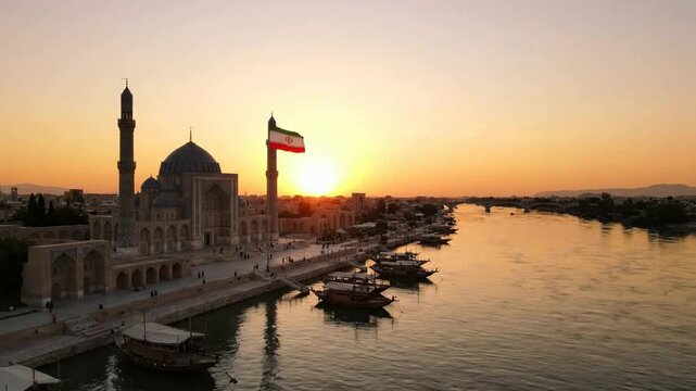Waving flag of iran at sunset over historic mosque and riverfront cityscape iranian flag middle east