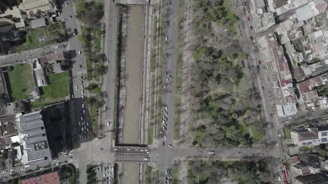 Overhead Drone Shot Following Mapocho River Towards Plaza Baquedano in Santiago