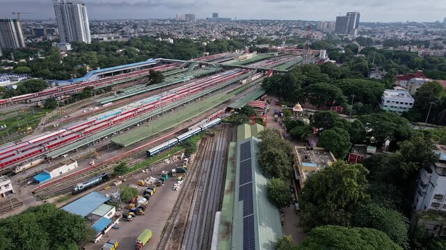 Aerial cinematic view of KSR bangalore city railway junction with trains highlights station infrastructure