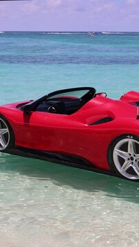 Red sports car shaped floating lounge craft in ocean water beach near George Town Grand Cayman, Cayman Islands