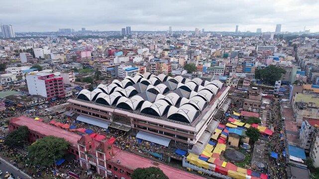 Cinematic drone view of KR market building amidst bangalore cityscape highlighting vibrant city trade