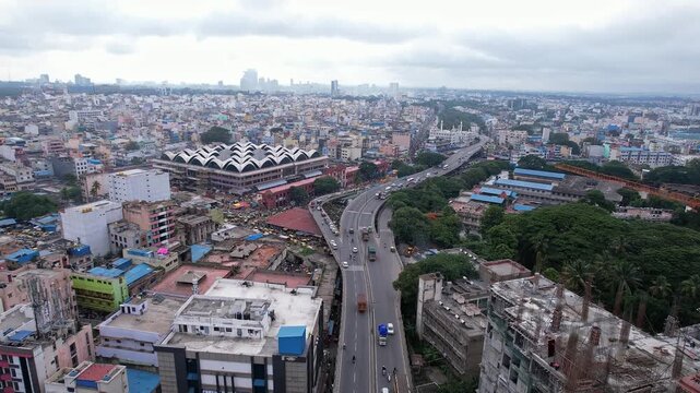 Cinematic drone view of KR market beside long ring road amidst busy bangalore cityscape