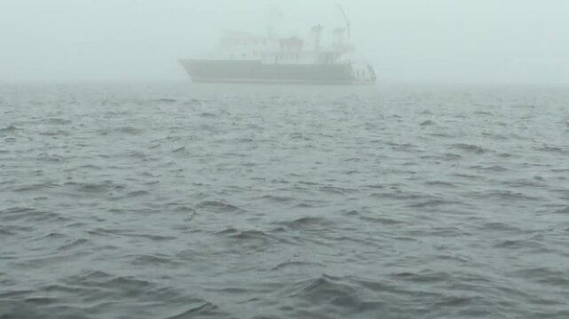 A ship travels across the Arctic Ocean while dark waves and swells move beneath the vessel, revealing the texture and motion of cold polar water. The source identifies the location near Norway.